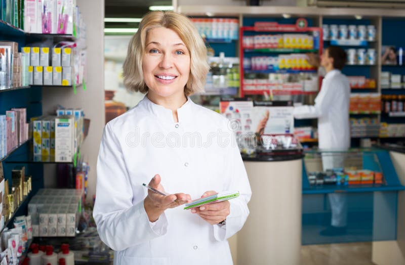 Portrait of positive female pharmacists working in modern farmacy