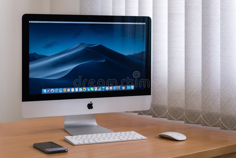 IMac monitor computers, keyboard, magic mouse, iPhone X on wooden table stock photo IMac monitor computers, keyboard, magic mouse, iPhone X on wooden table stock photo