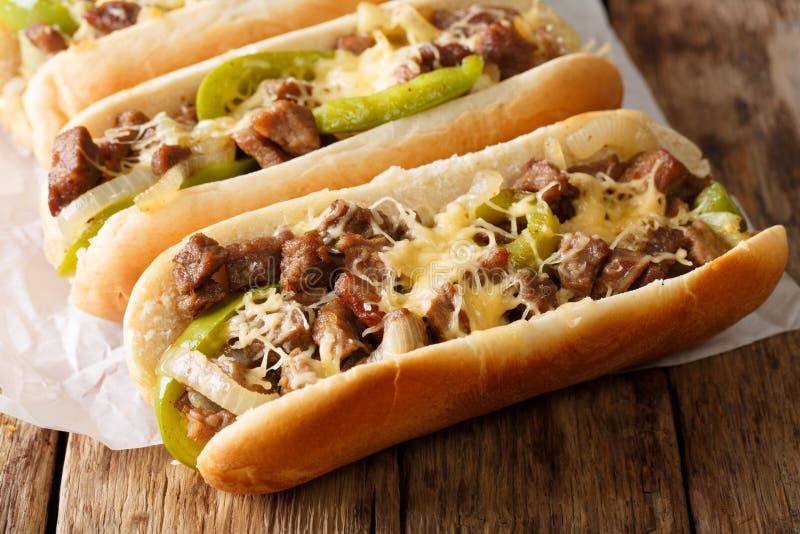 Philly cheese steak sandwich served on parchment paper close-up. Horizontal royalty free stock photography Philly cheese steak sandwich served on parchment paper close-up. Horizontal royalty free stock photography