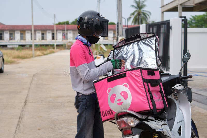 Phitsanulok, Thailand - May 24, 2020: Food order online via Foodpanda being delivered, Food panda rider deliver food at the front door of a residence, Foodpanda is a mobile food delivery marketplace
