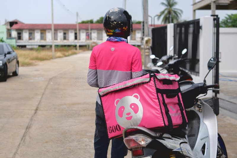 Phitsanulok, Thailand - May 24, 2020: Food order online via Foodpanda being delivered, Food panda rider deliver food at the front door of a residence, Foodpanda is a mobile food delivery marketplace