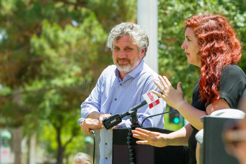 PHOENIX, ARIZONA-USA â€“ MAY 18, 2019- Del Bigtree rests on the podium while the mic glitches at the Arizona March for Medical Freedom at the State Capitol building. Rally to protect rights to make informed medical decisions. PHOENIX, ARIZONA-USA â€“ MAY 18, 2019- Del Bigtree rests on the podium while the mic glitches at the Arizona March for Medical Freedom at the State Capitol building. Rally to protect rights to make informed medical decisions