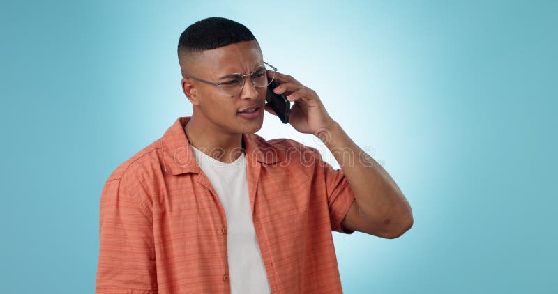 Phone call, communication and angry man talking in studio isolated on a blue background mockup space. Smartphone, chat stock video