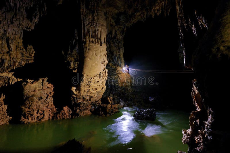 Phong Nha Ke national park / Vietnam, 16/11/2017: Group ziplining over an underground river inside the giant Hang Tien cave in the