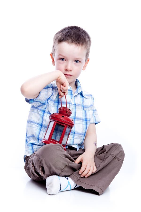 Photo of adorable young boy with red lamp