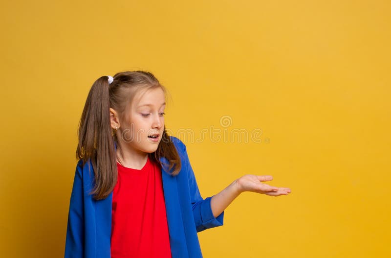 Photo attractive caucasian cute girl impressed astonished gesture hand wear red t-shirt and blu jacket on yellow background stock photography Photo attractive caucasian cute girl impressed astonished gesture hand wear red t-shirt and blu jacket on yellow background stock photography