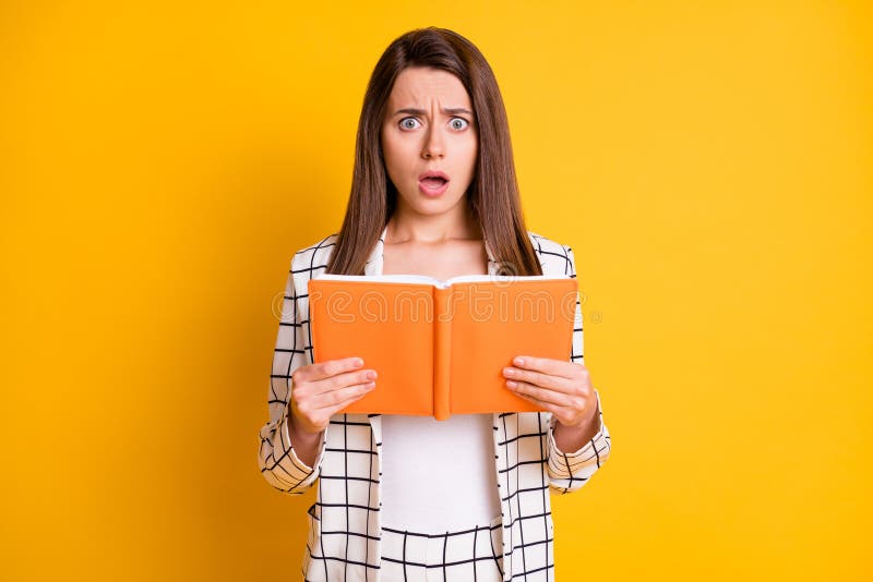 Photo of attractive surprised woman wear checkered outfit reading book scary plot open mouth isolated yellow color stock photos