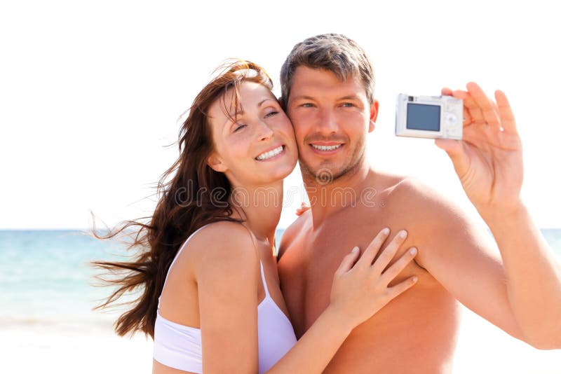 Summer couple taking self portrait photo on the beach. Summer couple taking self portrait photo on the beach