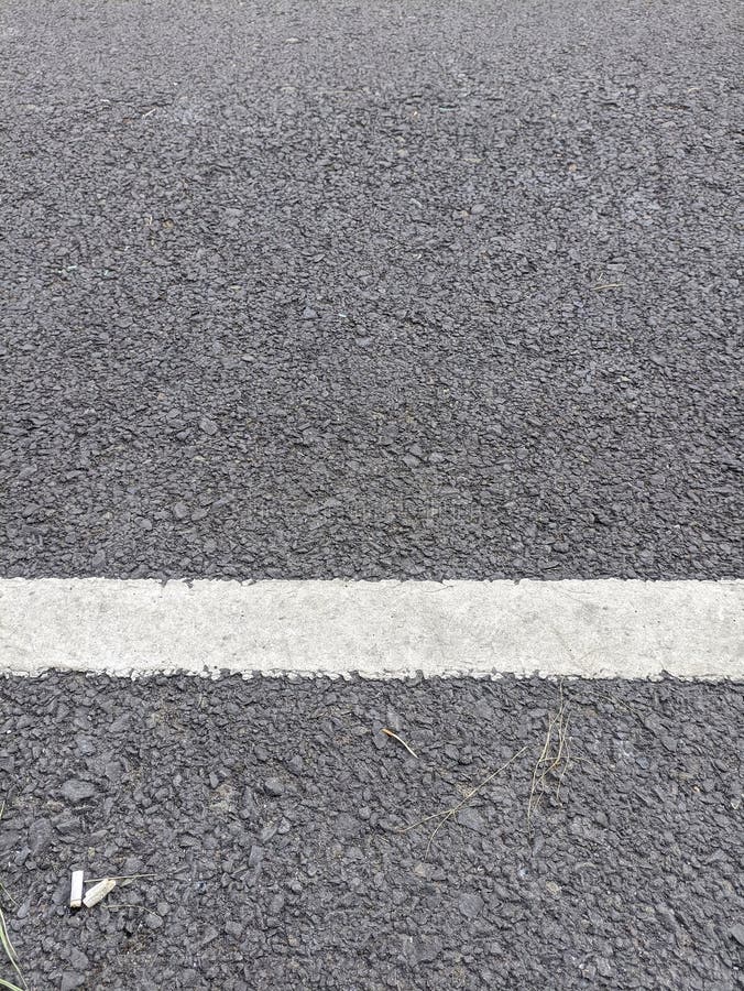 A Photo of a Black Asphalt Road with White Road Lines Stock Image