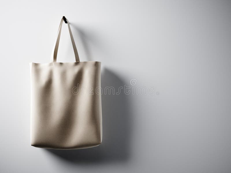 Photo black cotton textile bag hanging in left side. Empty white wall background. Highly detailed texture, space for stock photos