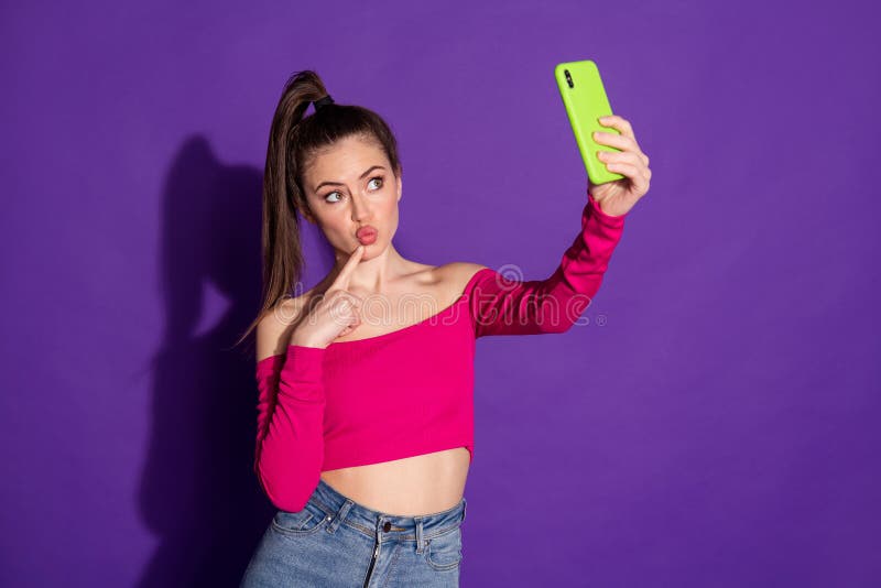 Photo Of Blogger Girl Hold Cellphone Make Selfie Finger Face Wear Pink Top Isolated Purple Color