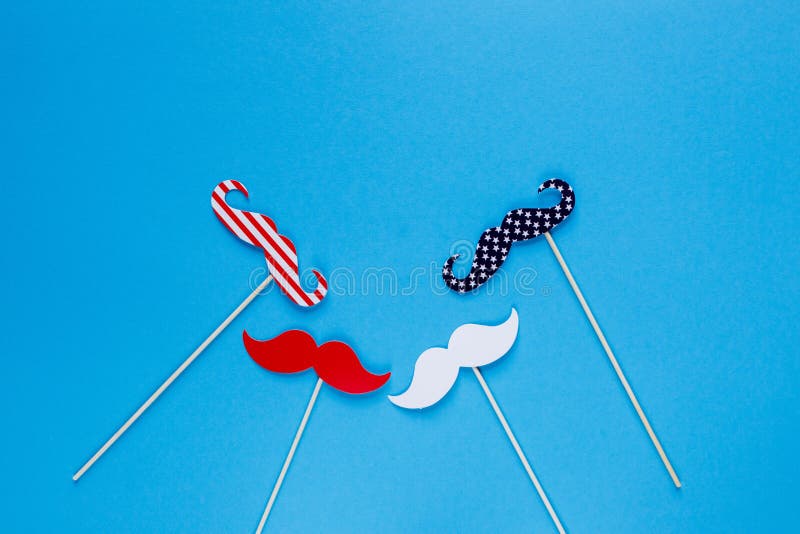 Photo booth for 4th of July. Moustache on sticks on blue background. American flag colors. Independence Day royalty free stock photos Photo booth for 4th of July. Moustache on sticks on blue background. American flag colors. Independence Day royalty free stock photos