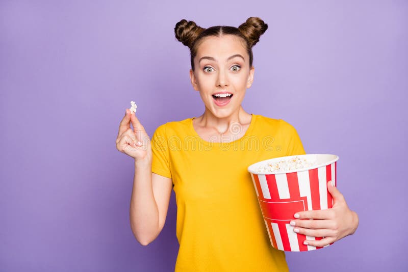 Photo of brunette white trendy cheerful millennial watching movie excited about unexpected events in plot holidng bucket royalty free stock image