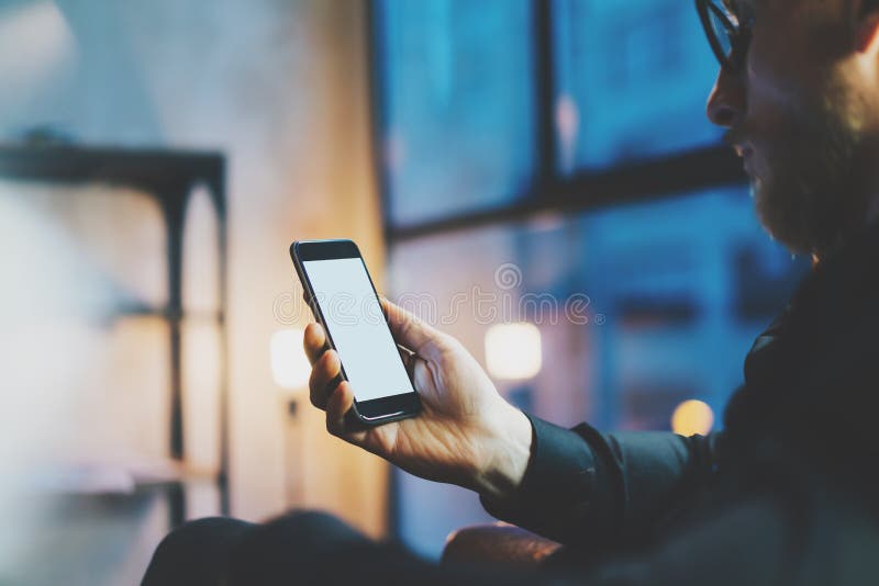 Photo businessman relaxing modern loft office.Man sitting chair night.Using contemporary smartphone,blurred background royalty free stock photos Photo businessman relaxing modern loft office.Man sitting chair night.Using contemporary smartphone,blurred background royalty free stock photos