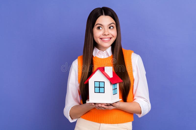 Photo of charming minded girl hands hold small house look empty space brainstorming isolated on violet color background.