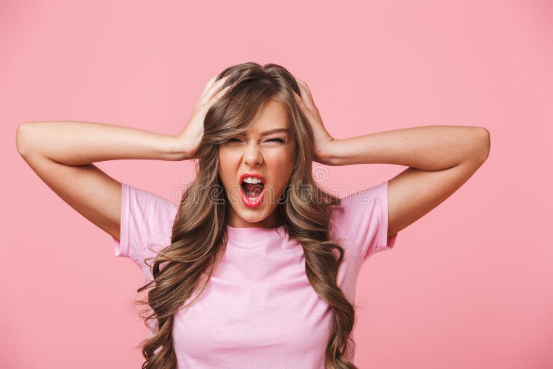 Photo closeup of annoyed angry woman with long curly hair in basic t-shirt covering ears and screaming because of terrible royalty free stock image Photo closeup of annoyed angry woman with long curly hair in basic t-shirt covering ears and screaming because of terrible royalty free stock image