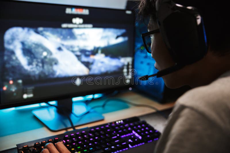 Boy play game on gaming PC online. Stock Photo