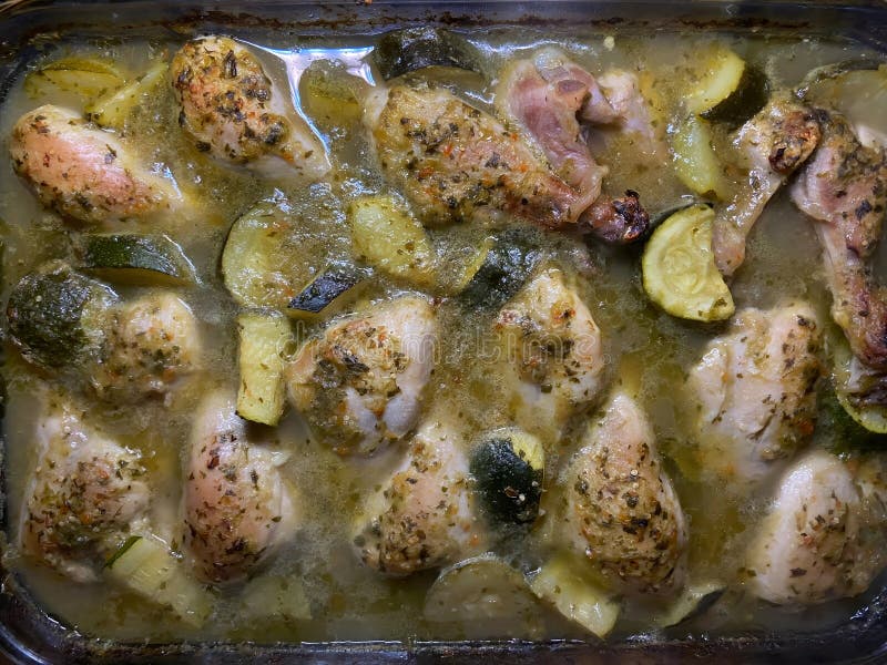 Baked Spicy Chicken Legs In Tomatillo Salsa With Squash Stock Photo baked-spicy-chicken-legs-in-tomatillo-salsa-with-squash-stock-photo