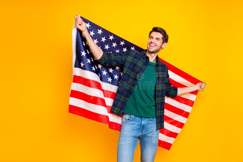 Photo of cool guy holding usa flag in hands exchange program student wear casual plaid shirt and jeans isolated yellow royalty free stock photo Photo of cool guy holding usa flag in hands exchange program student wear casual plaid shirt and jeans isolated yellow royalty free stock photo