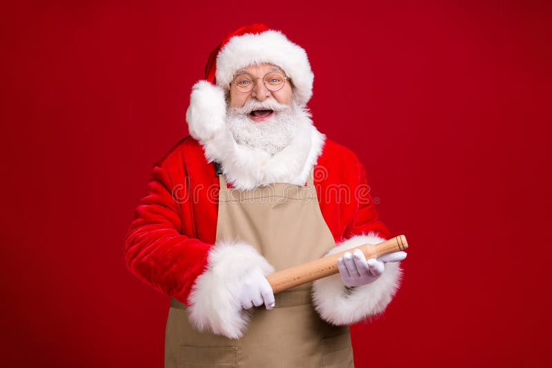 Photo of crazy stylish modern grey bearded santa claus hold rolling pin x-mas christmas meal preparation wear apron red royalty free stock photos