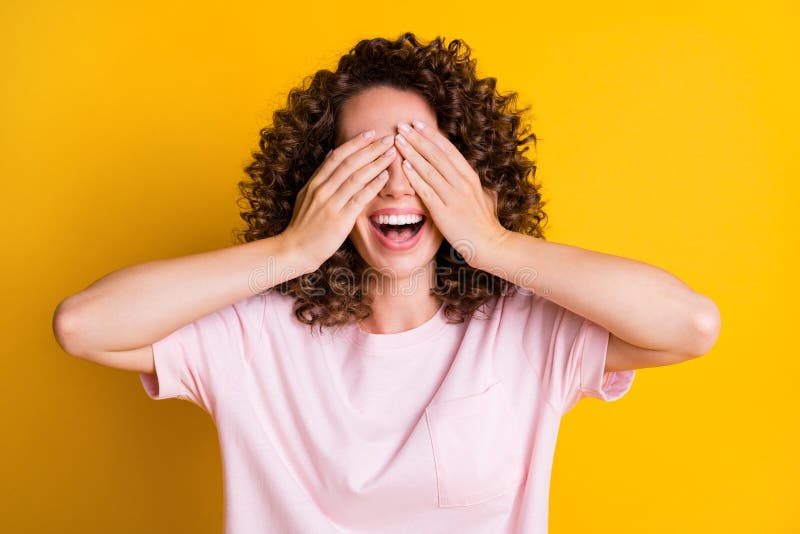 Photo of curly brown hair positive happy smile girl hands cover close eyes  over yellow color background