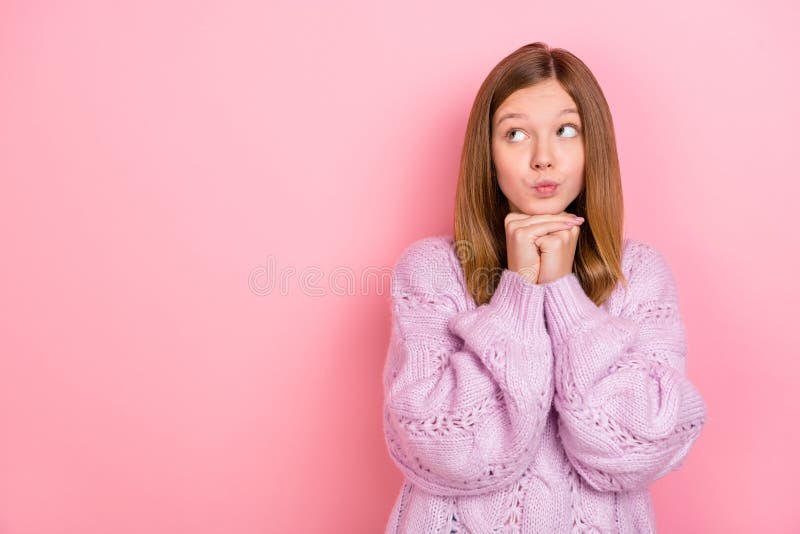 Photo of doubtful unsure girl dressed knitted pullover looking empty space isolated pink color background