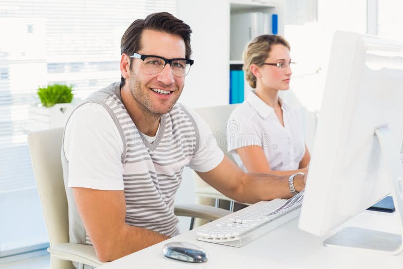 Photo Editor Sitting at Desk Looking at Camera Stock Image - Image of