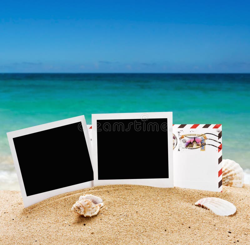 Photo frame and a letter from vacation in the sand