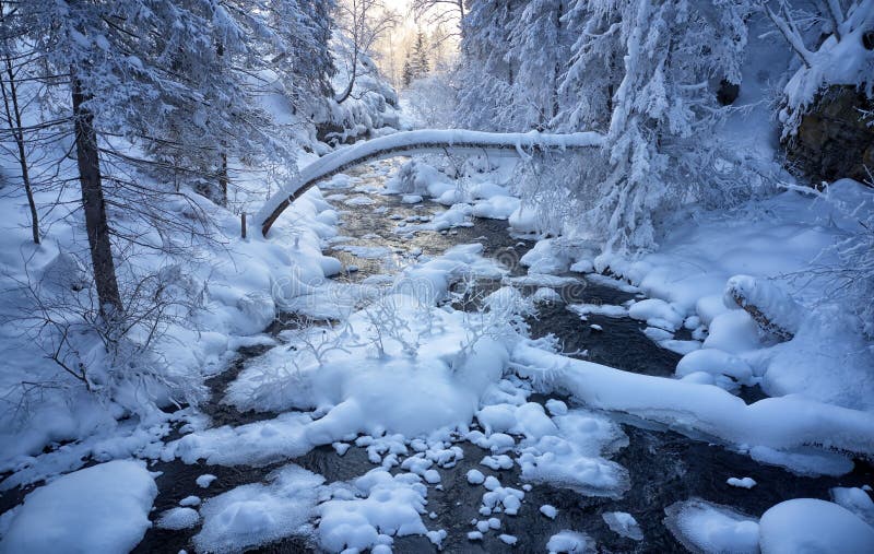 Photo of frozen river Pescherka near waterfall in winter. Siberia, Russia