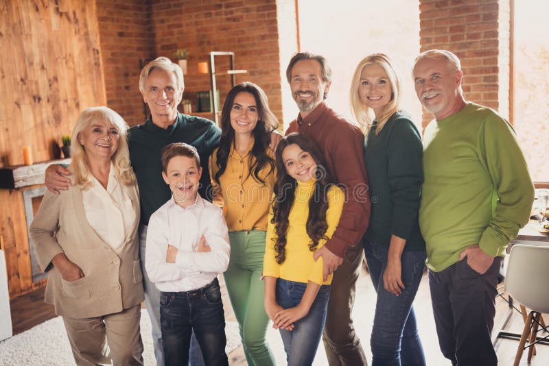 Photo of Full Family Gathering Eight People Two Small Kids Embrace