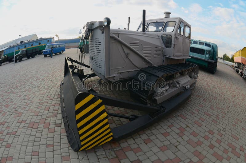Download Photo Of A Gray Bulldozer Among The Railway Trains. Strong ...