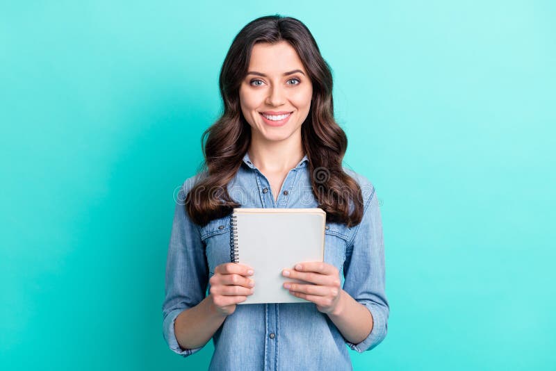 Photo of happy attractive nice young woman hold hand notebook smile isolated on pastel teal color background