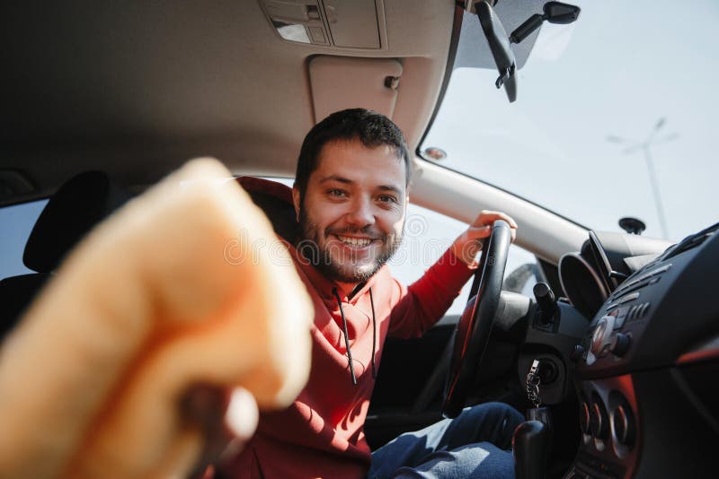 Photo of happy male with orange rag washing salon of car,close up