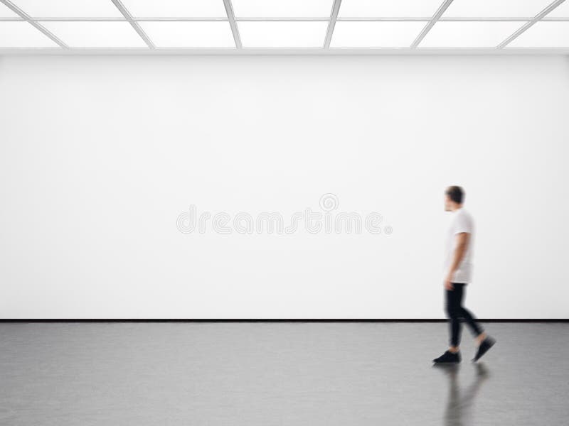 Photo of hipster in modern gallery looking at the empty canvas. Blank mockup, motion blur