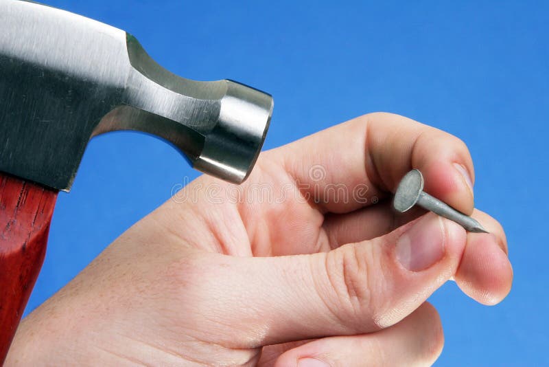 Photo of Man Hammering A Nail