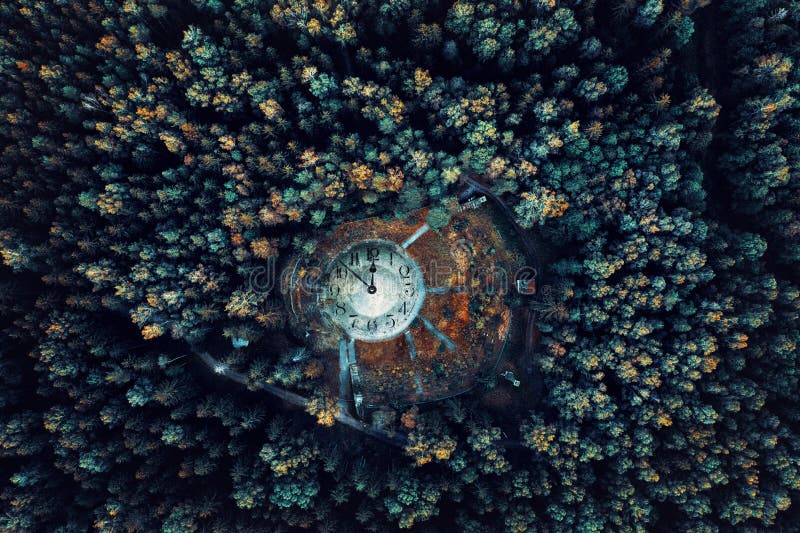 Photo manipulation,  aerial view of a huge clock in the forest