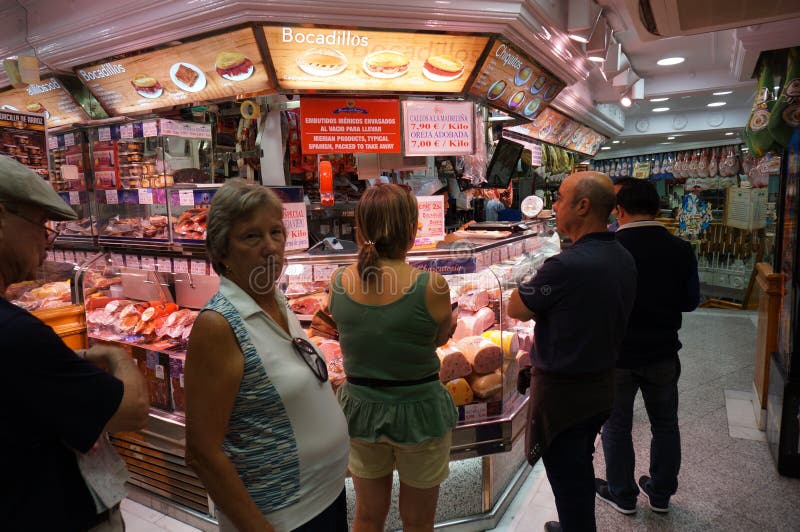 Shopping for Fine Hams and meats for Sale at a Shop in Madrid Spain. Photo of people shopping for fine hams and meats for sale at a shop in madrid spain on 10/4/ royalty free stock photos Shopping for Fine Hams and meats for Sale at a Shop in Madrid Spain. Photo of people shopping for fine hams and meats for sale at a shop in madrid spain on 10/4/ royalty free stock photos