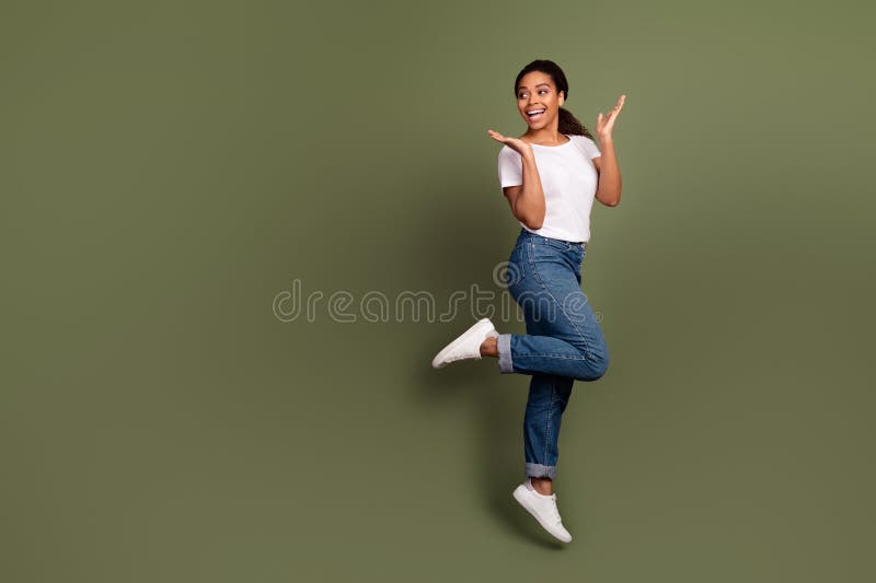 Photo pleine longueur de la fille américaine porter t-shirt blanc et jeans levé les mains regarder la publicité espace vide isolé photo libre de droits