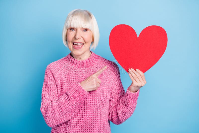 Photo Portrait Of Amazed Old Woman Holding Big Red Heart Card In One 