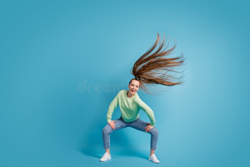 Photo portrait of girl dancing twerk with flying hair isolated on pastel blue colored background