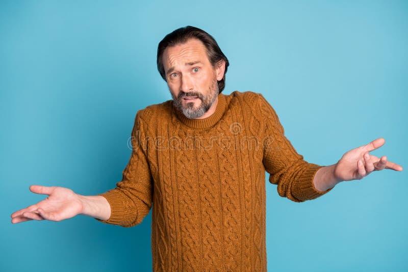 Photo portrait of unsure clueless man shrugging shoulders gesturing hands isolated on vivid blue color background