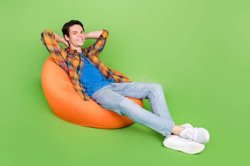 Photo of Positive Cheerful Guy Sit Bean Bag Have Rest Break Wear Plaid ...