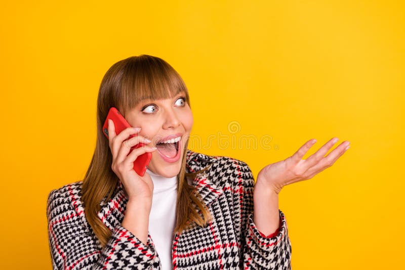 Photo of positive girl speak phone open mouth hand explain wear plaid outfit isolated on yellow color background