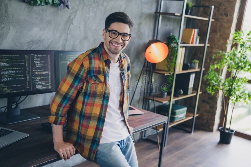 Photo of positive intelligent it company developer sitting desktop modern spacious business center inside stock images