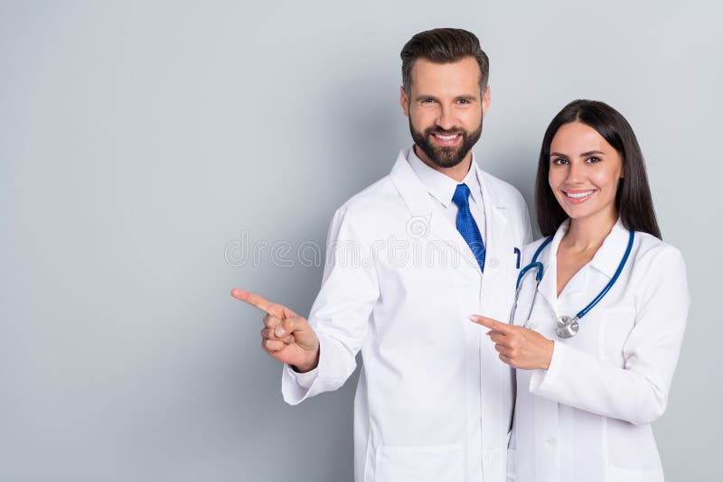 Photo of Positive Pretty Two Doctors Wear White Coats Pointing Empty