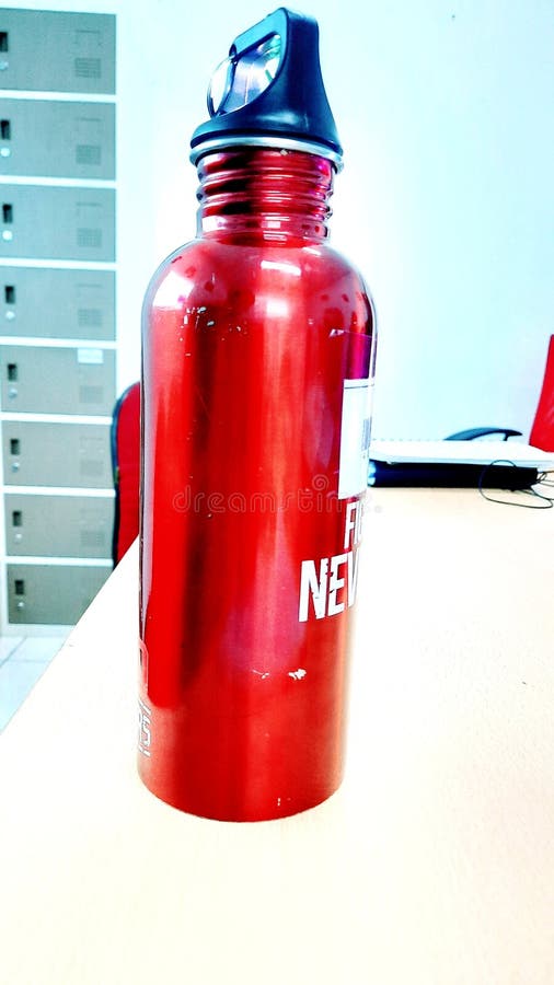 Photo of a Red Water Bottle on the Office Desk Editorial Photo Image