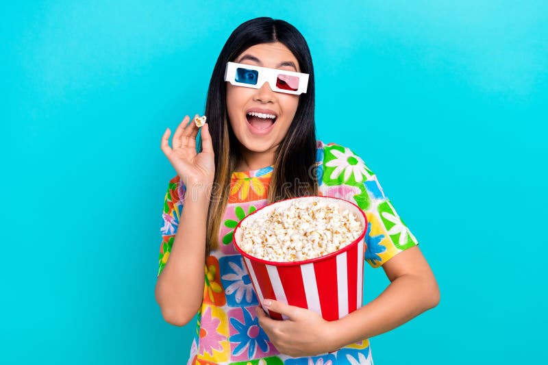 Photo of shiny excited lady wear flower print t-shirt throwing pop corn watching 3d movie  blue color background.