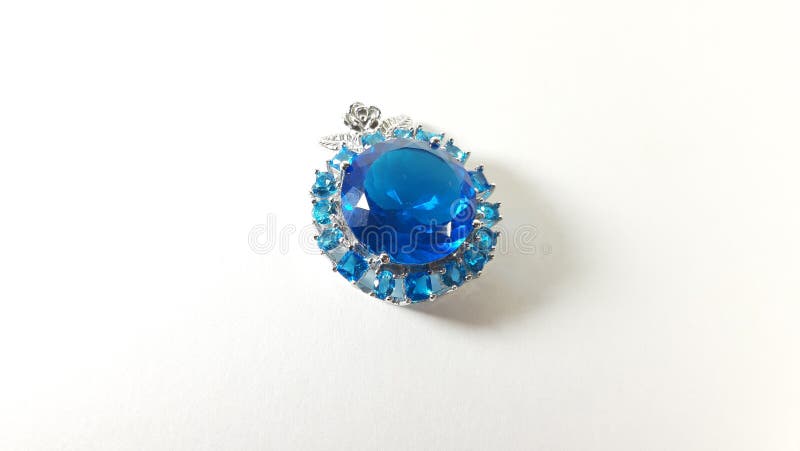 Photo silver pendant with blue stone topaz on a white background, the image of the gift royalty free stock photos