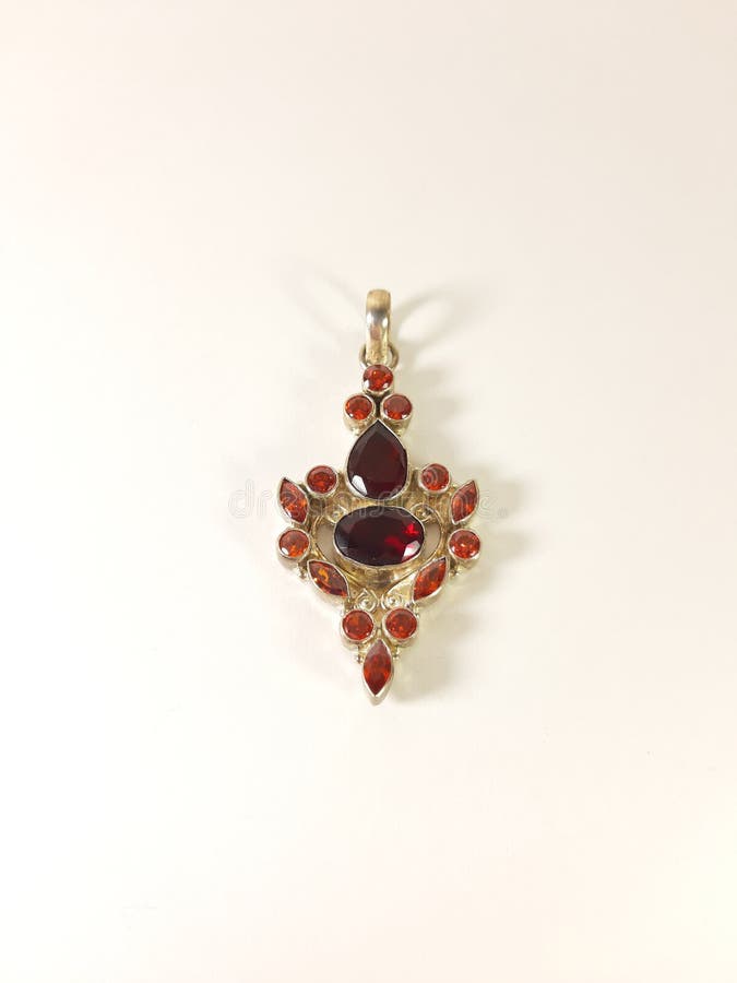 Photo silver pendant with red stone on a white background, the image gift royalty free stock images