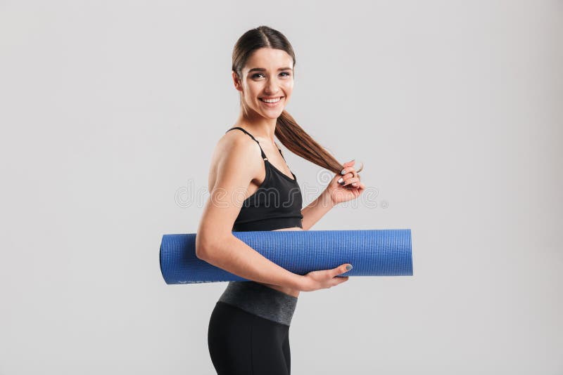 Photo of Slim Young Woman in Tracksuit Holding Yoga Mat and Look Stock ...